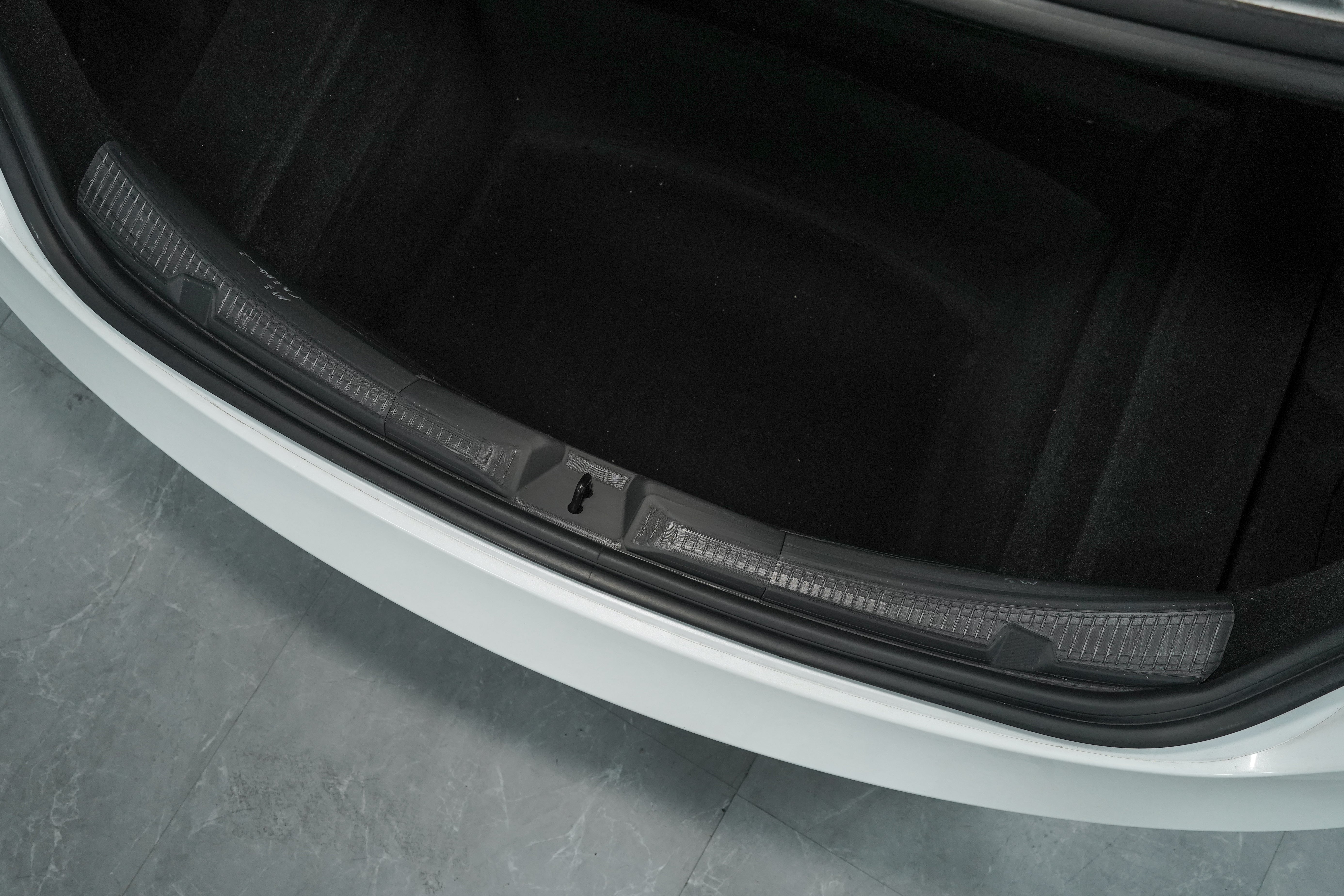 BASENOR single-piece TPE trunk sill guard installed on a 2024+ Tesla Model 3 Highland, following the full factory contour